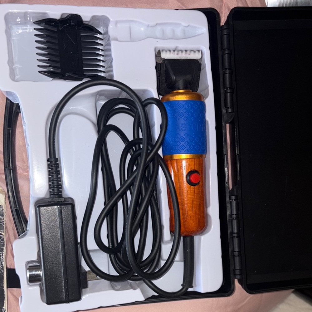 Electric Hair Trimmer with Blue and Orange Handle for Tufting Carpets.
